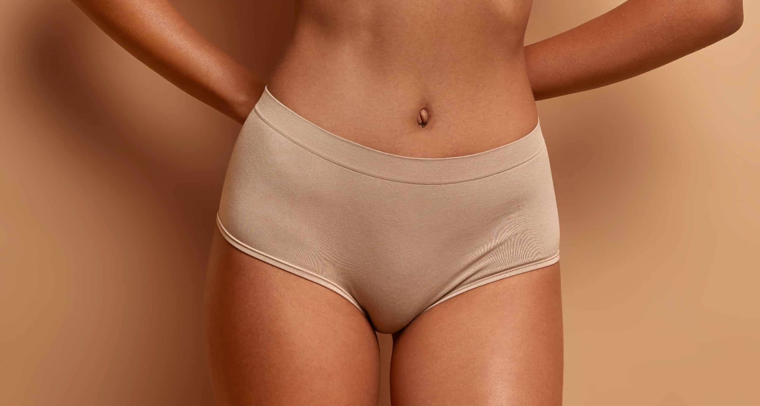 Body care concept dark skinned woman wears lingerie ha flat belly slender legs 2