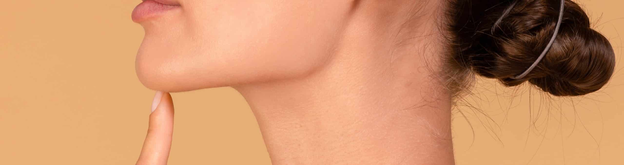 Chin augmentation side view unrecognizable young woman touching her face happy with result plastic surgery 1