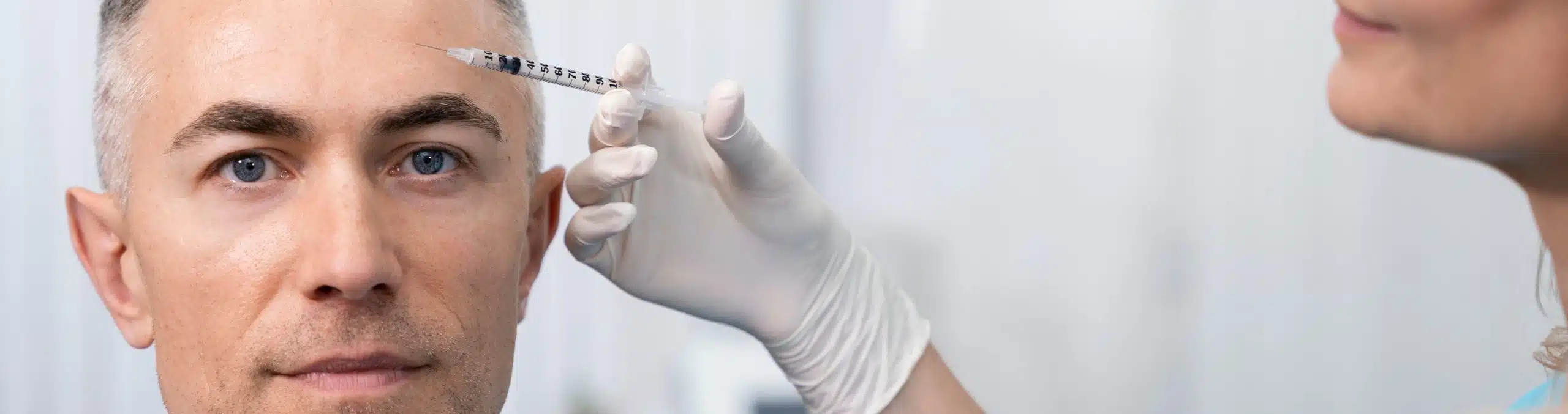 Clinician holding a syringe