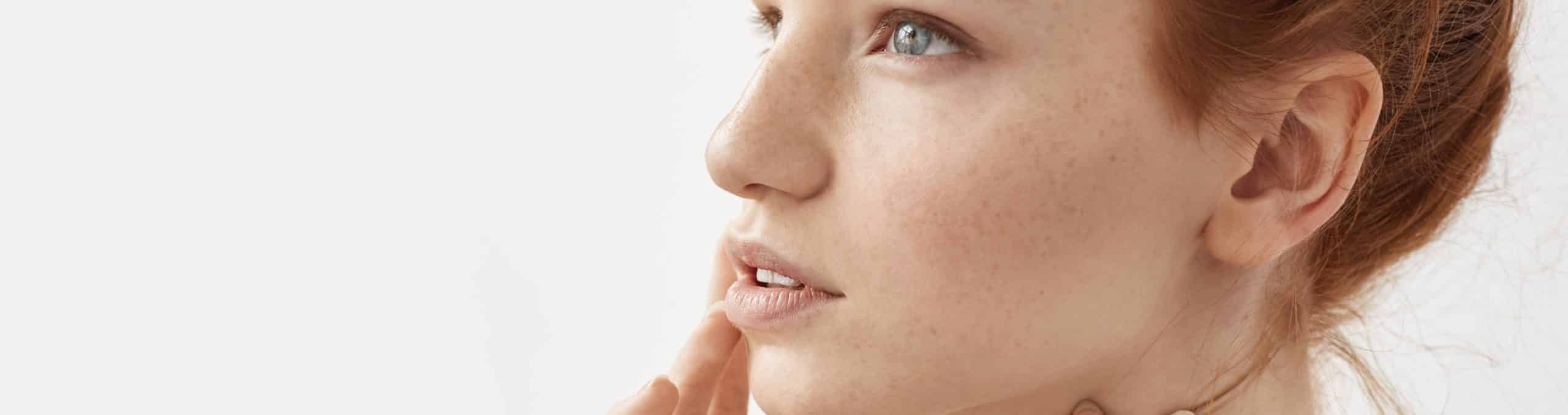 Close up portrait ginger woman with freckles posing 1