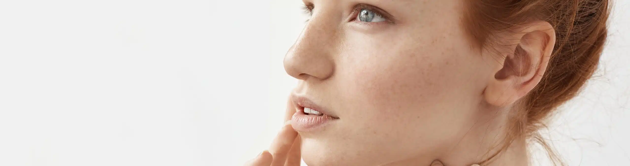Close-up portrait of a red-haired woman with freckles