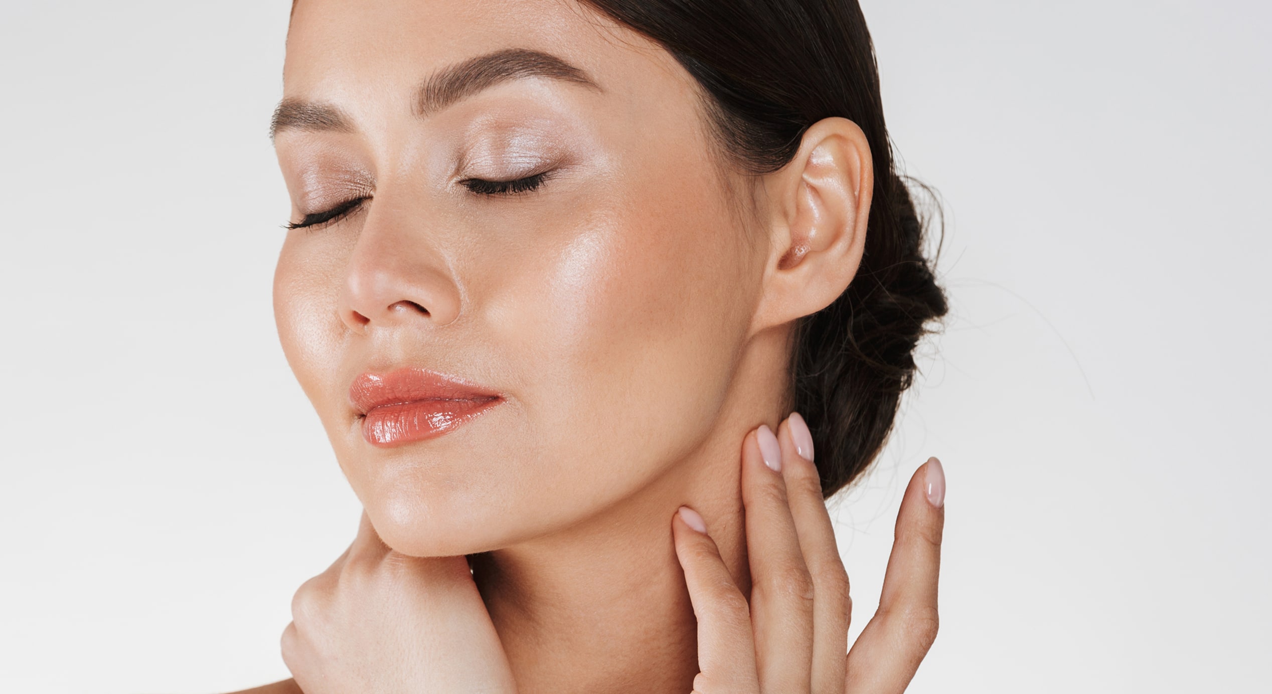 Close up relaxed brunette woman with soft skin posing camera with closed eyes isolated white 1