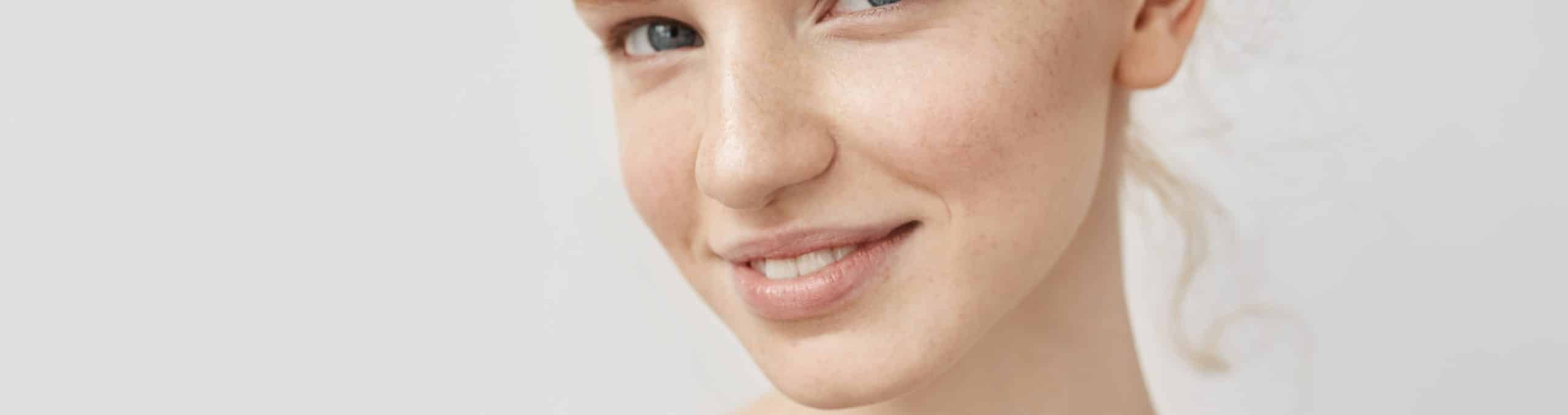 Closeup portrait redhead woman with freckles smiling 1 1