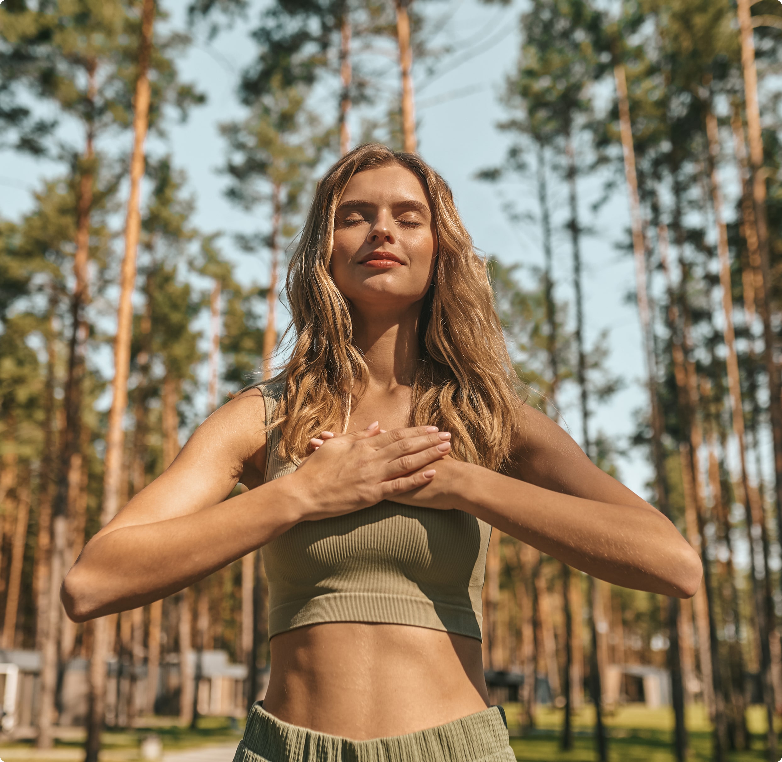 Cute blonde woman practising yoga outside looking relaxed 3