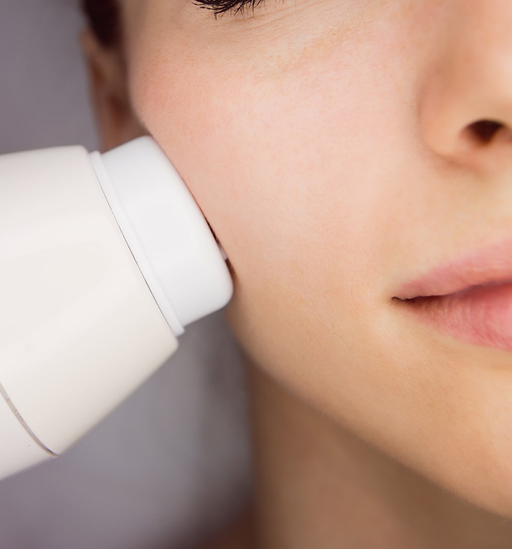 Dermatologist giving facial massage through sonic lifting 1 1