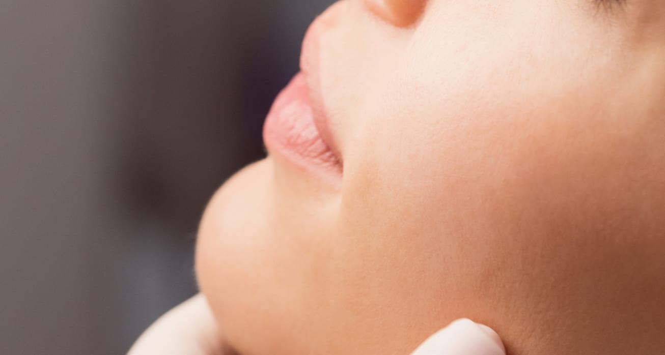 Doctor examining womans face cosmetic treatment 1