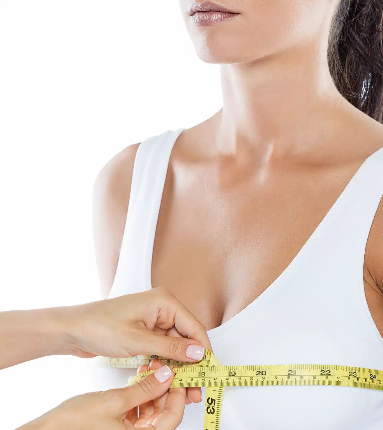 Clinician measuring a patient's breast with a measuring tape