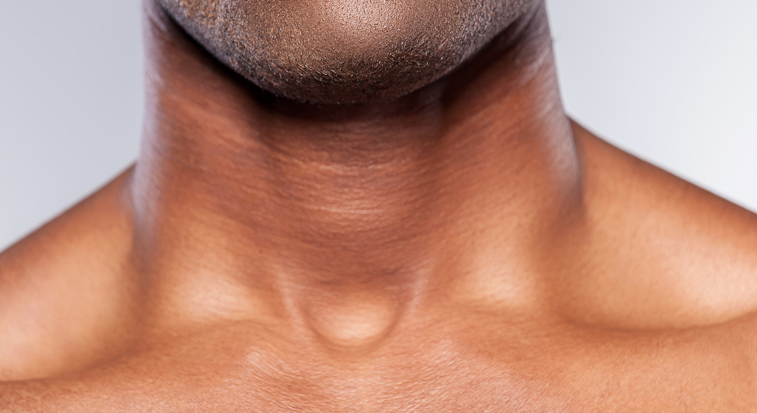 Feeling doubt cropped young african man grimacing while standing against grey background 1