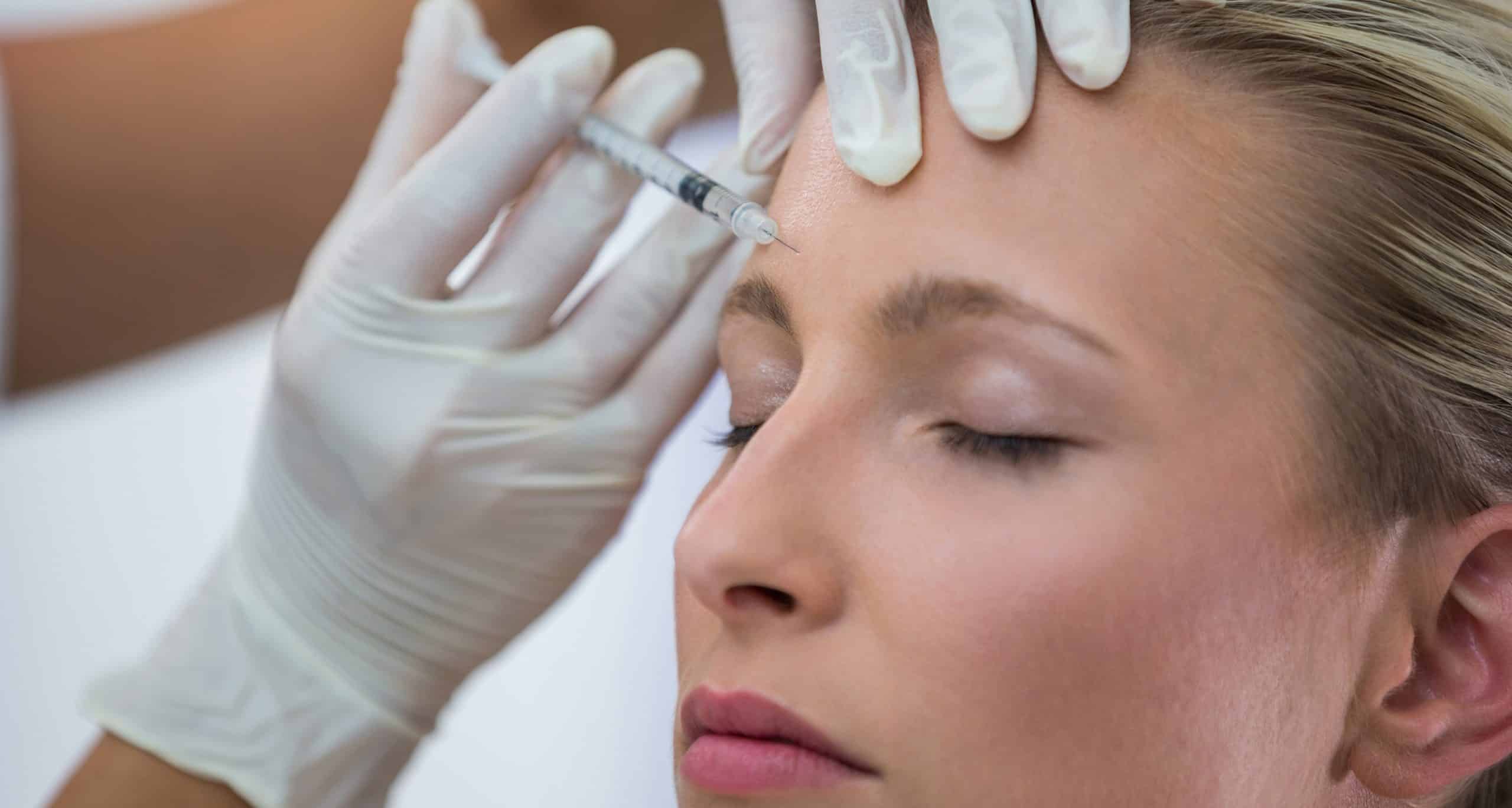 Female patient receiving botox injection forehead 1