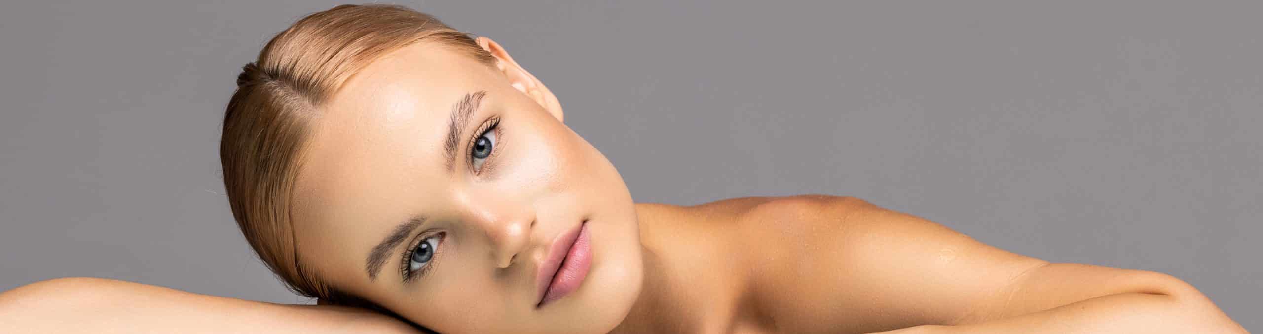 Healthy skin young woman beautiful face close up gray background 1