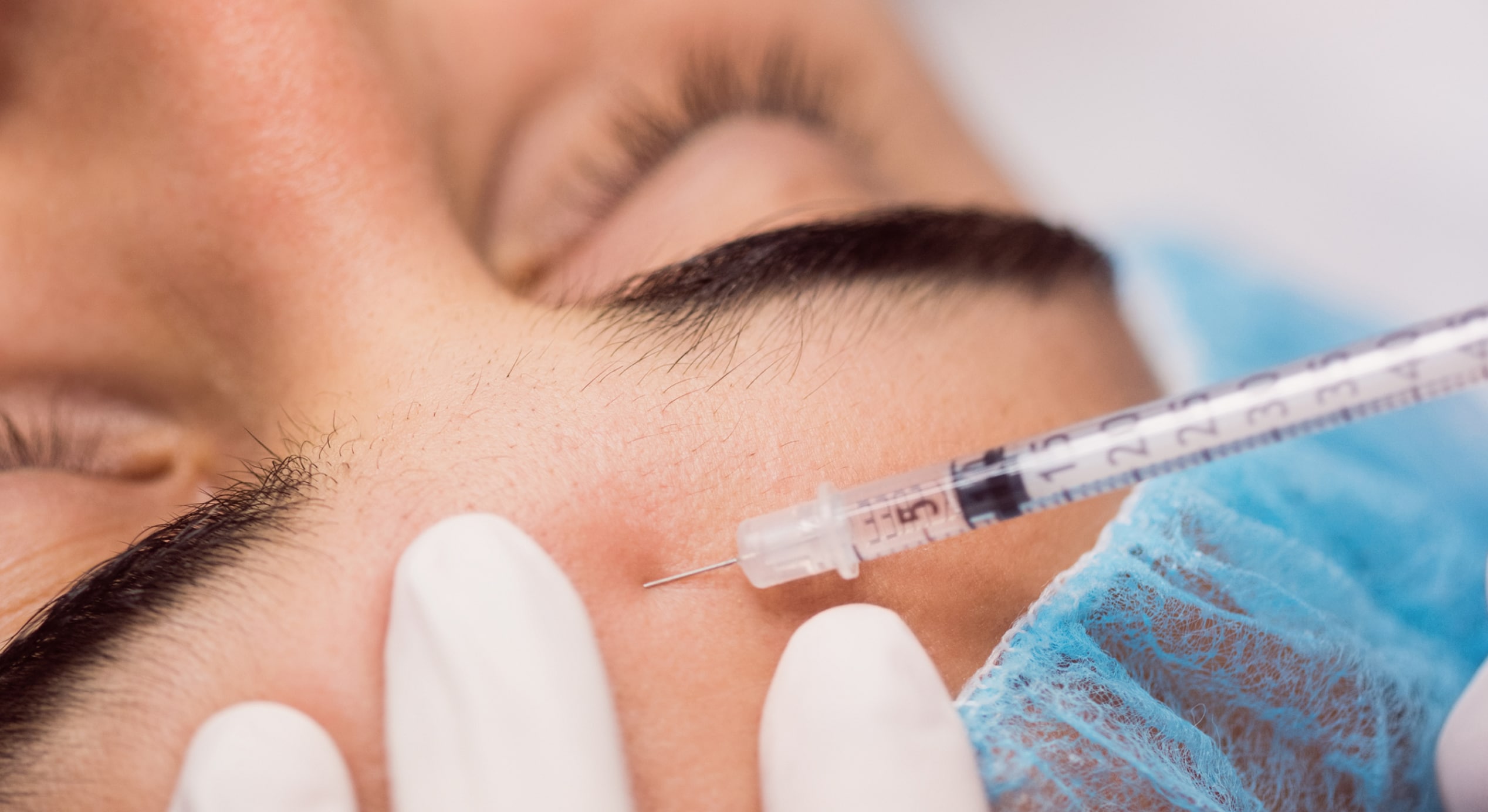 Man receiving botox injection his forehead 1