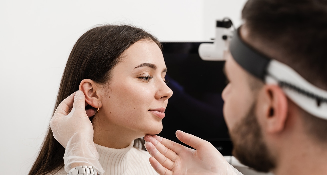 Otoplasty ear surgery surgeon doctor examines girl ears before otoplasty cosmetic surgery otoplasty surgical reshaping…