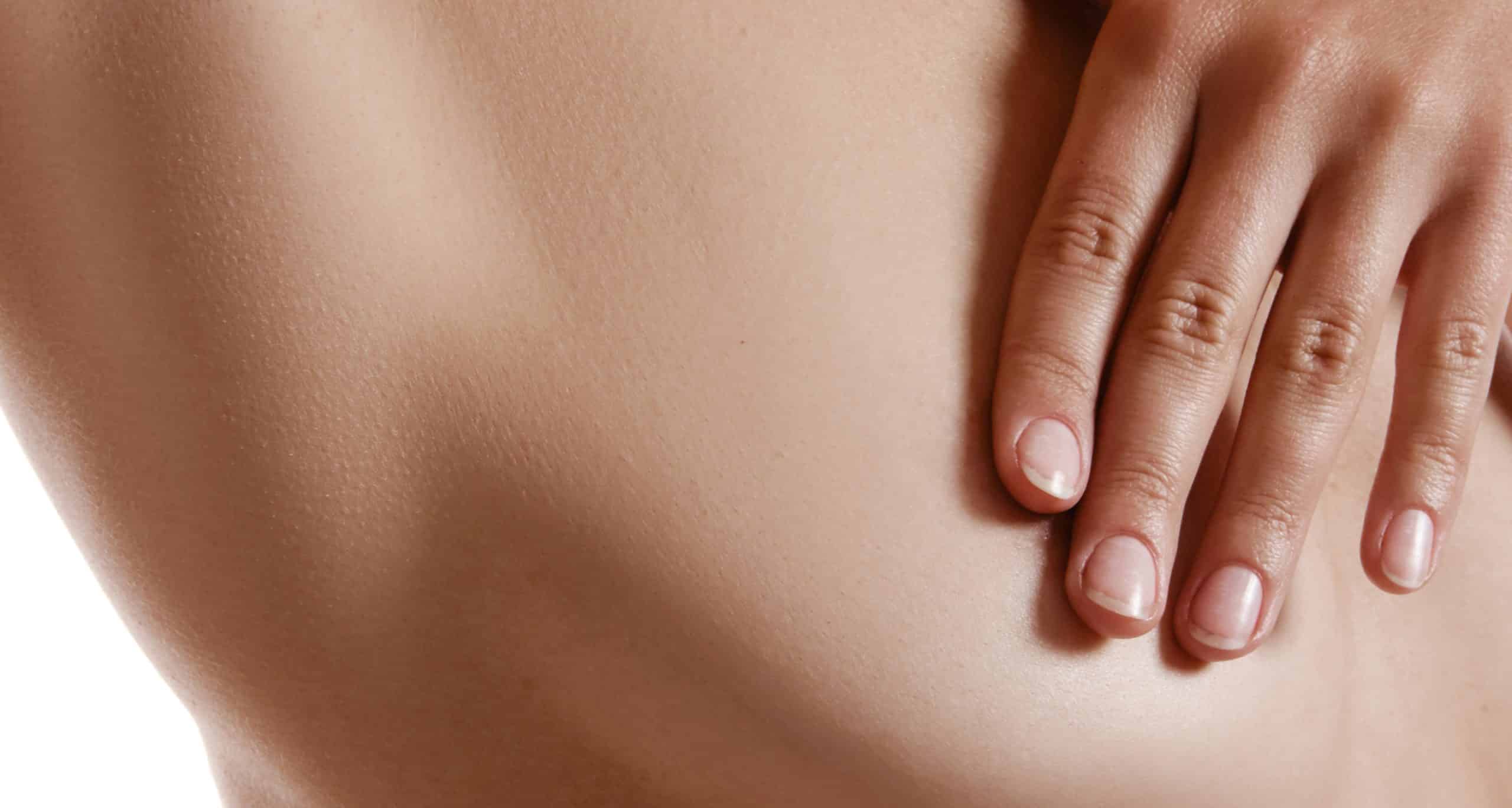 Perfect nude body girl covering her breast with hands posing isolated white plastic surgery 1