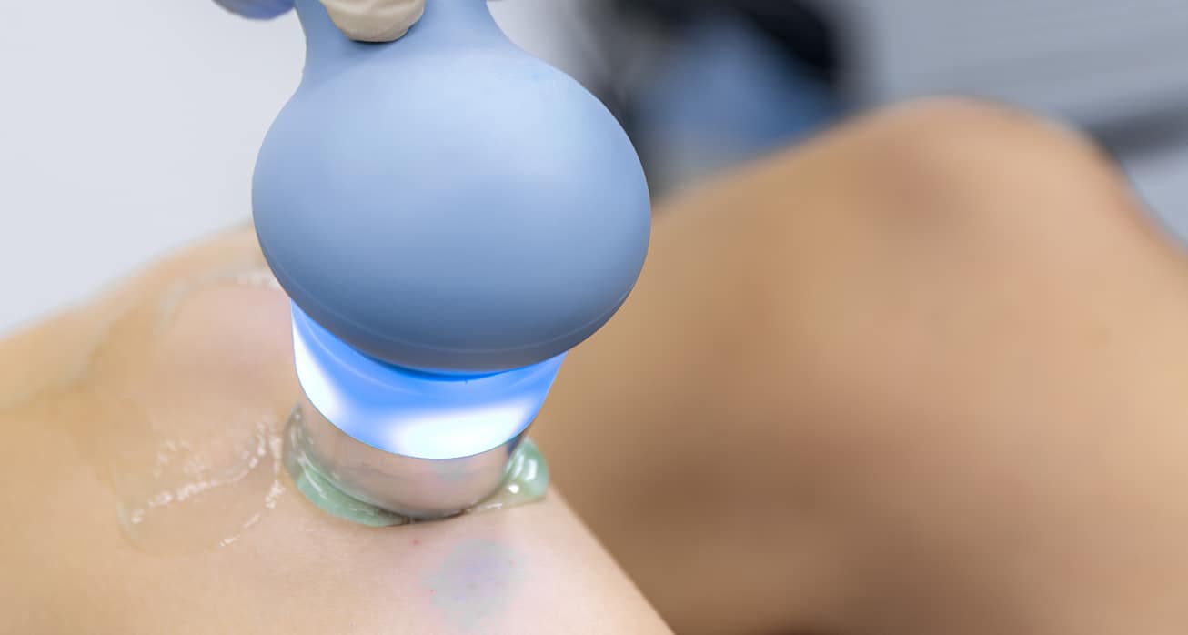 Physiotherapist performs ultrasound therapy female patient knee joint rehabilitation 1