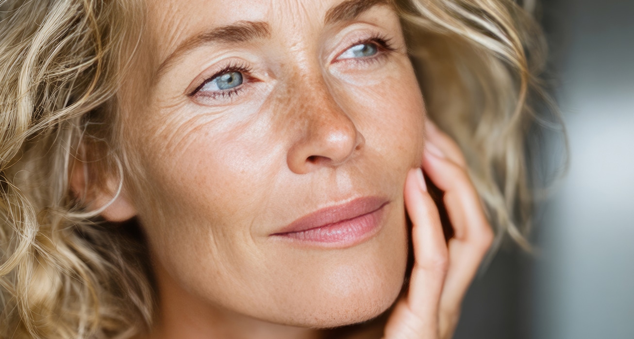 Portrait beautiful mature woman gently touching face looking away 1 1