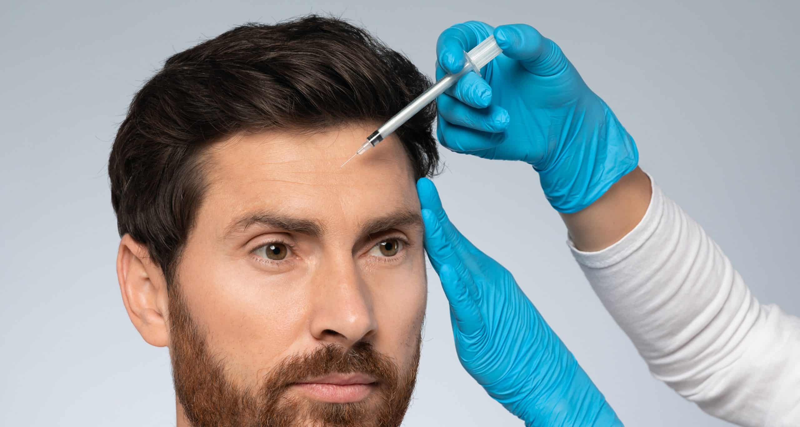 Revitalizing beauty middle aged man receiving filler injection into forehead zone willing look 1