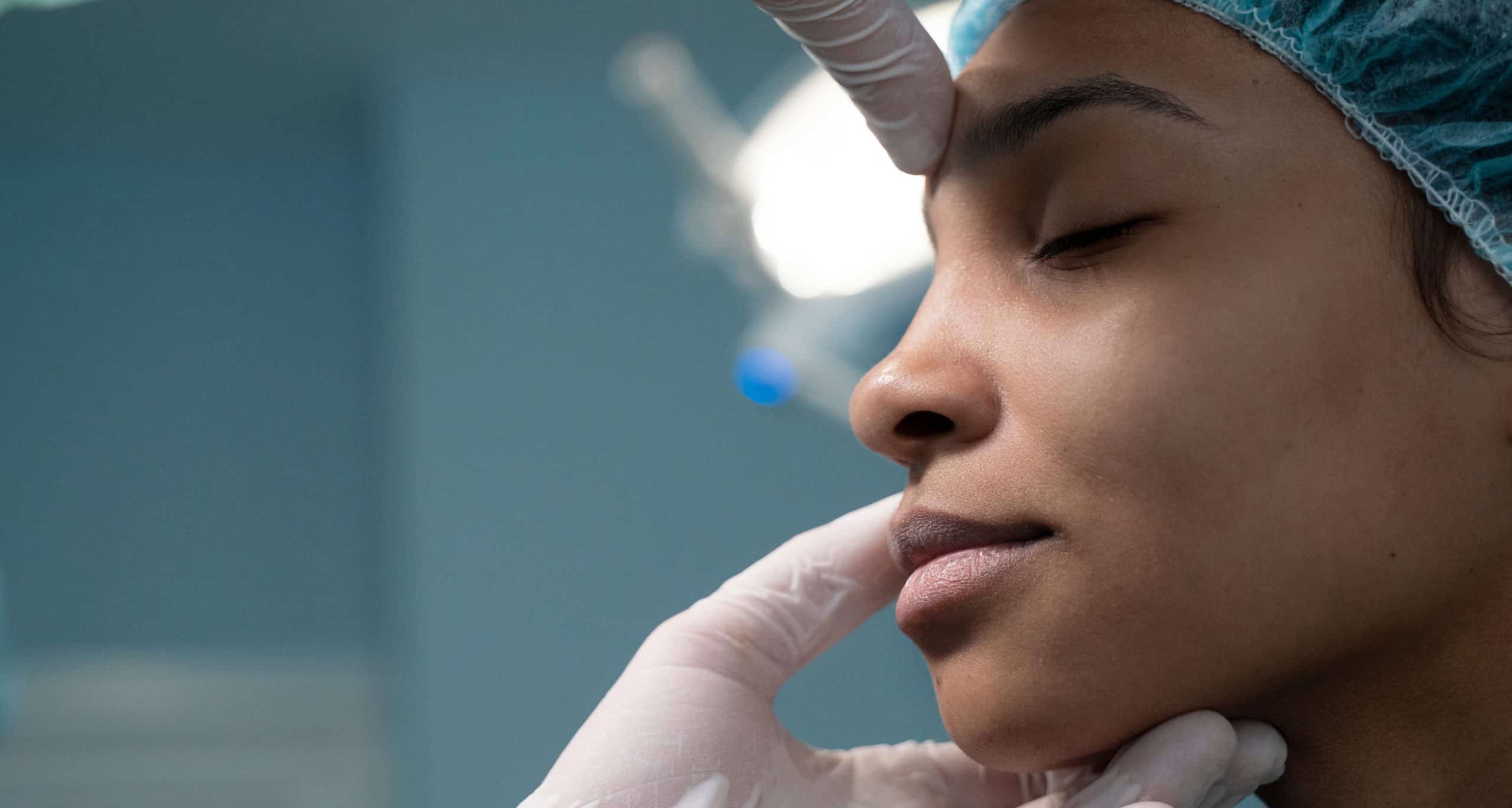 Side view doctor checking patient before rhinoplasty 1 1
