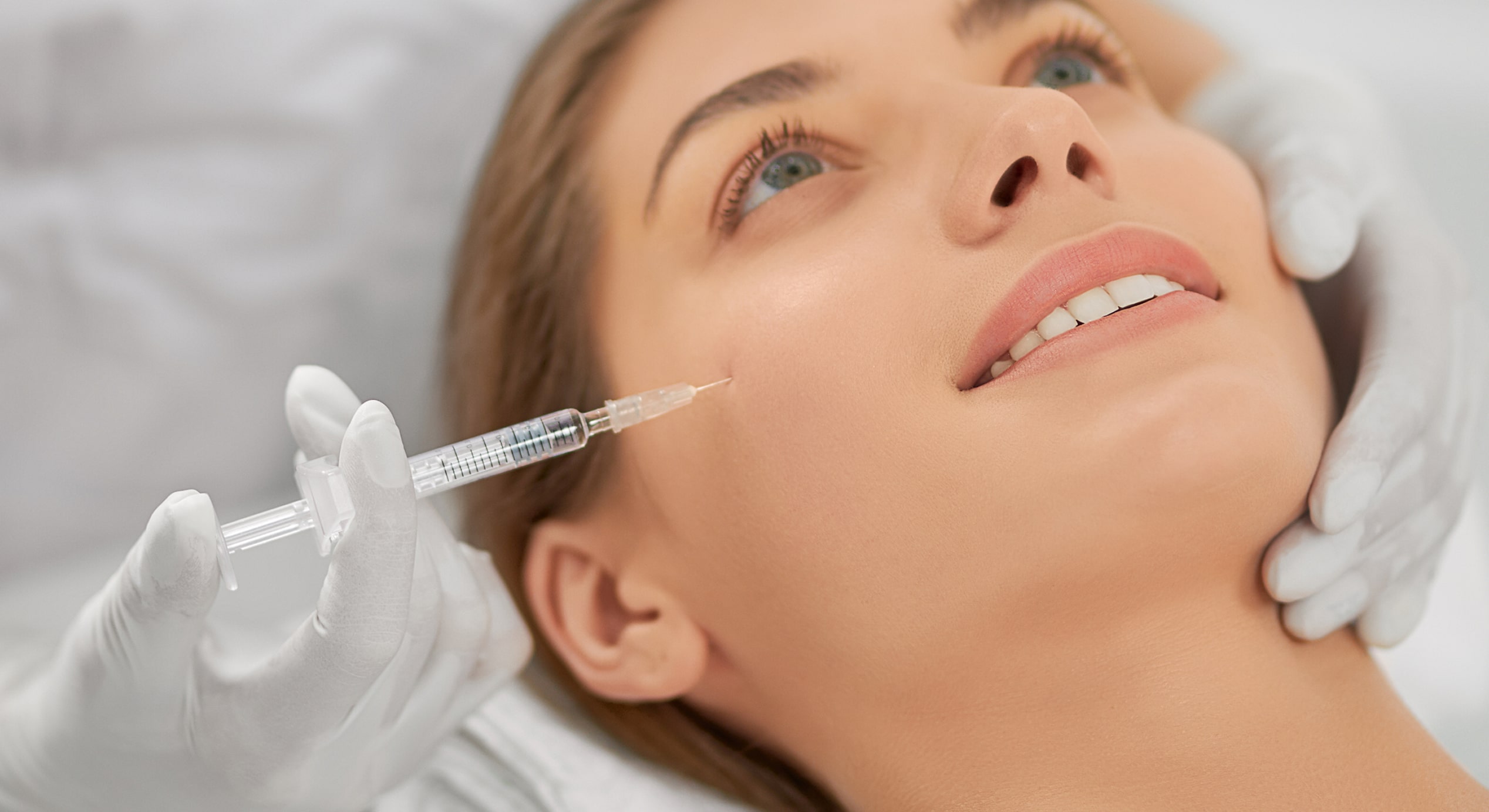 Smiling woman doing procedure tighten skin 1