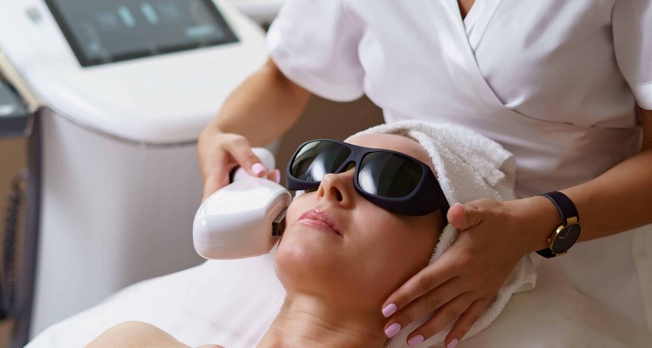 View doctor cosmetologist doing anti aging procedure cosmetology office satisfied woman disposable hat lying couch…