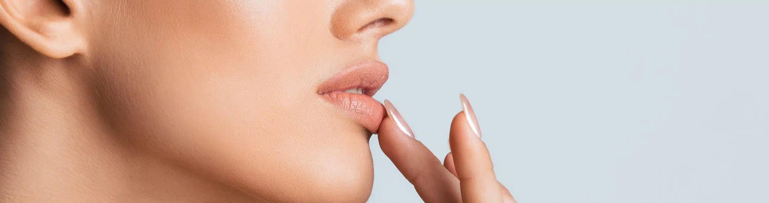 Woman in profile touching her lower lip