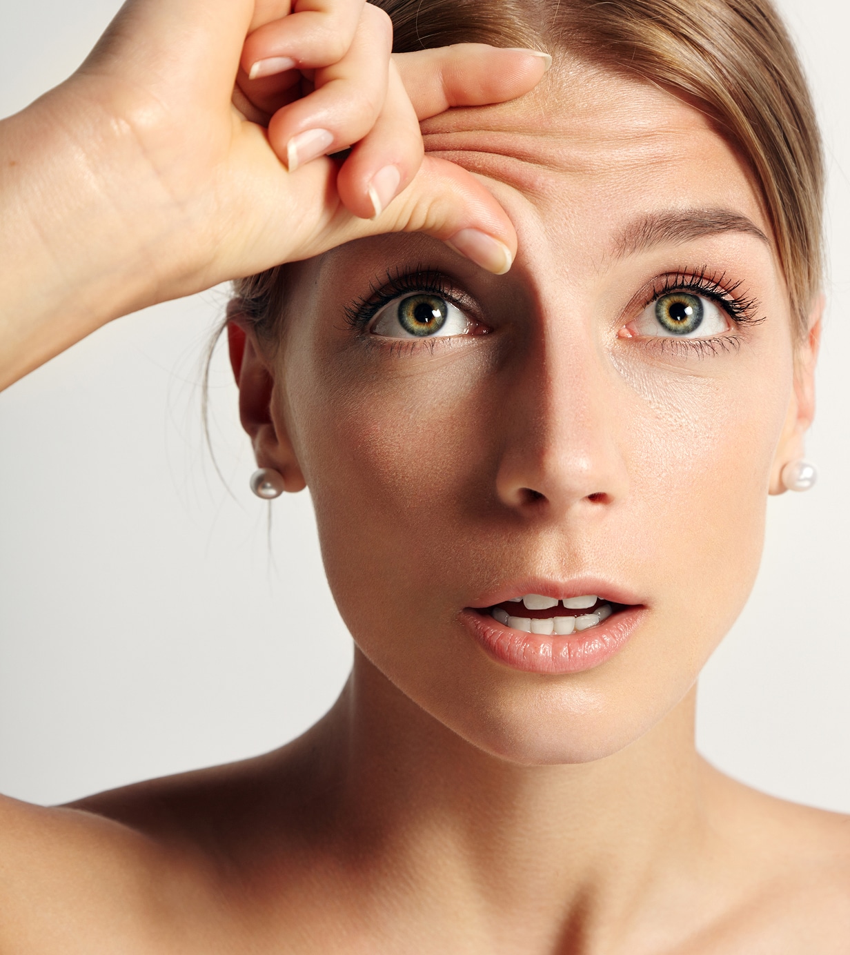 Young beauty woman wondering that she have wrinkles her forehead 1